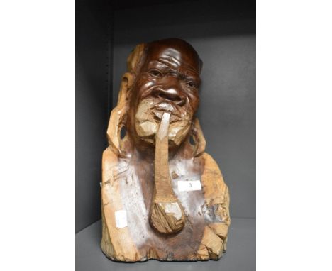 A Carved wood African bust, depicting man smoking a pipe.