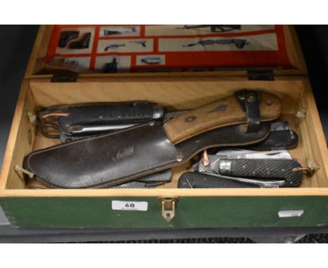 A box of vintage knives, multi tools, including Military issue.