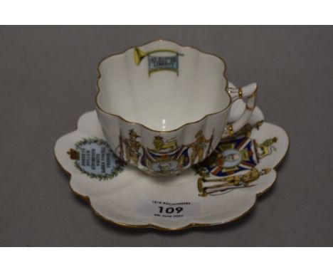 A collectable cup and saucer ' Colonies supporters of the Empire volunteers to swag below depiction of three soldiers and lio