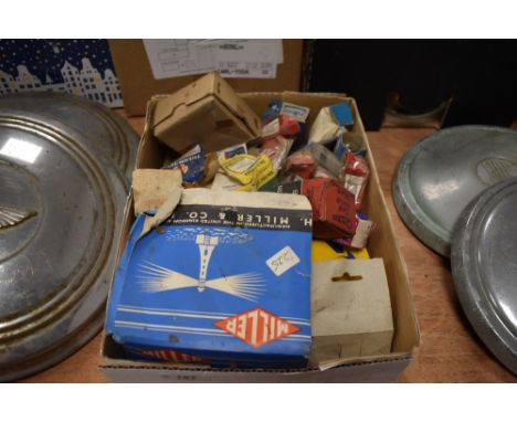 A box of parts and spares, most boxed, including spark plugs, head lamp, bulbs etc.