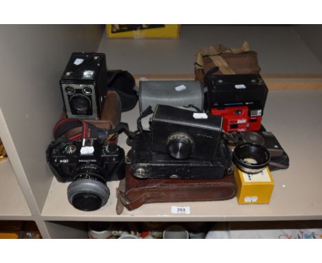 A variety of vintage cameras and a lens, Praktica sport, Praktica BX20, Kodak Cresta 3, Kodak Instamatic 33 and more.