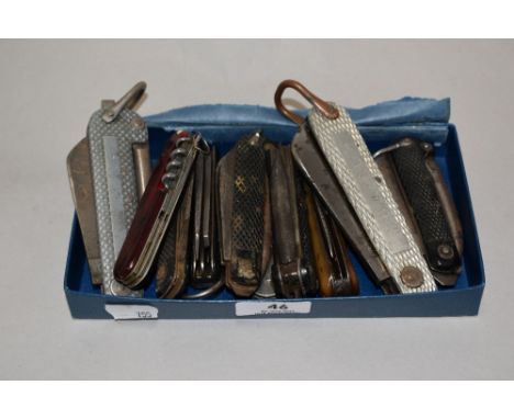 An assortment of vintage pocket knives and multi tools, including 1943 dated military issue.