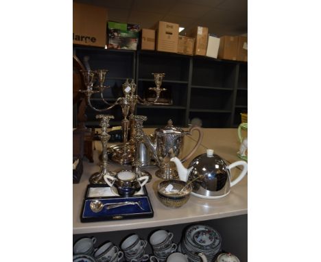 A mixed lot of plated ware, amongst which are candlesticks, boxed childrens spoon and pusher, and coffee pot, also included i