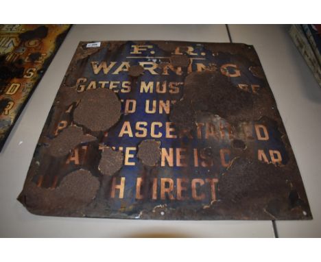 A distressed vintage enamel railway sign, 'F.R warning....'