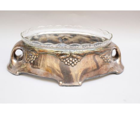 Silver plated Jardiniere, with curved base two handgrips and wine leave decorations, with original cutted transparent glass  