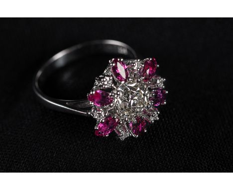 White gold Ring 585 , with a central diamond and other diamonds  1,46 carat and rubies.