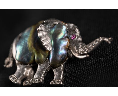 Brooch in form of an elephant, 750/1000 white gold and 0.3K diamonds; signed by O.B.(Wilhelm); with one ruby and abalone. 4.8