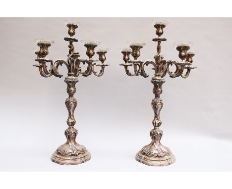 Pair of large silver Candelabra in Roccoco style each with six brunches and spouts the upper part remouvable for conversion i