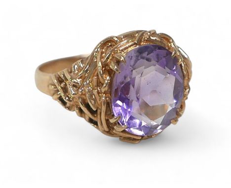 A 9ct gold amethyst ring, the oval cut stone approximately 10 by 12mm, size P, 5.2g.