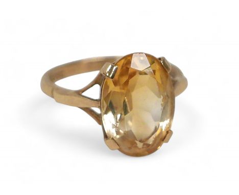 A 9ct gold citrine dress ring, the oval cut stone approximately, 10 by 14mm, size M, 3.3g, with original ring box.
