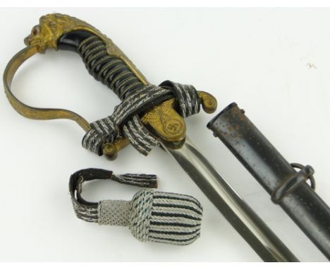A Third Reich German Officer's sword,
circa 1920/30, with cast gilt brass handle and original metal scabbard, blade length 32