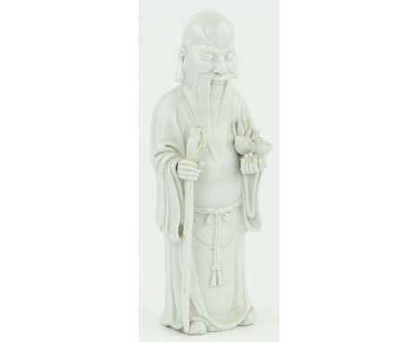 A Chinese blanc de chine porcelain figure of a sage,
holding a staff & lotus flower, unmarked, height 12.5"