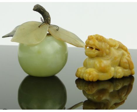 A Chinese carved jade lion with a lizard on his back,
length 3", together with a jade apple with jade leaves (2)