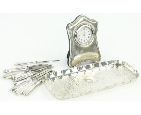 A silver dressing table tray,
London 1905, a modern silver fronted clock and silver handled manicure items.