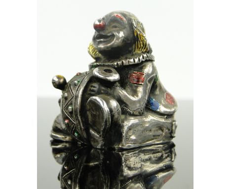 A modern silver and enamel clown design candle holder,
by Alessandro Magrino, import marks London 1993, height 4cm.