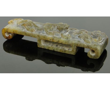 A Chinese carved jade scabbard mount,
with relief carved dragon & serpent design, length 5"