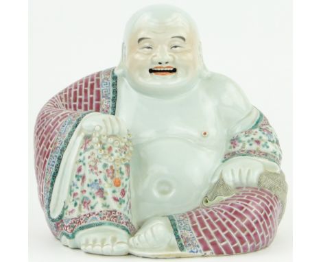 A Chinese famille rose porcelain seated Buddha,
Guangxu period 1875 - 1908, height 10", width 11", impressed seal mark under