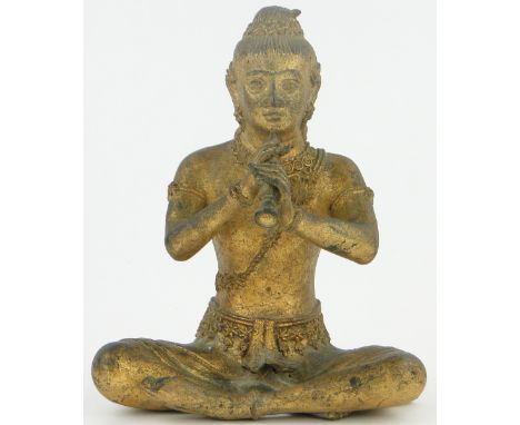 An Oriental gilded bronze seated figure playing a flute,
height 7.5".