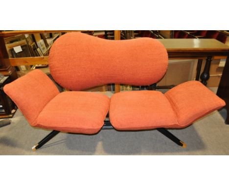 A Retro design sofa with upholstered cushions.