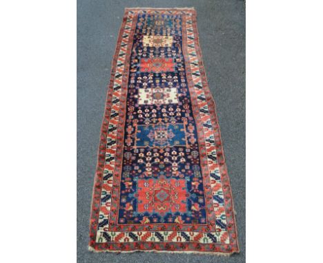 A red ground runner with 6 medallion centre panel,
length 14'2" x 3'10".
