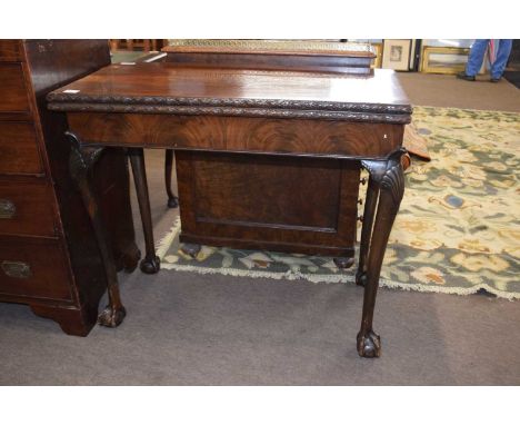 Late 19th Century walnut card table with folding top over shell carved knees and ball and claw feet, 91cm wide