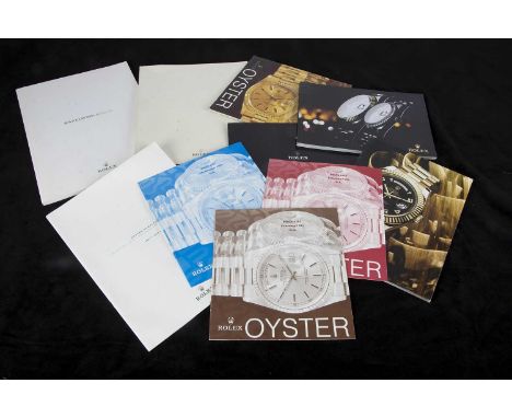 A collection of watch manufacturers catalogues and price lists, with examples from Rolex, IWC, Zenith, and others, along with