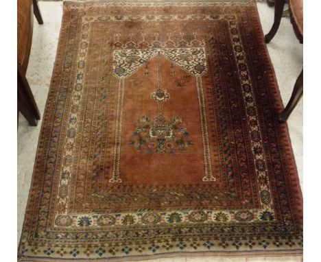 A Mahib design carpet, the central panel on red ground within a stepped red, blue and cream floral decorated border, approx 1