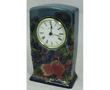 A Walter Moorcroft clock decorated with bird amongst peaches and cherries, inscribed to base