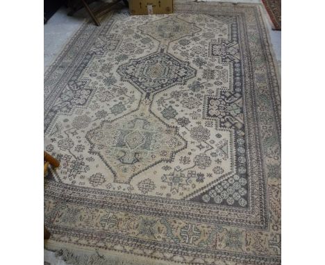 A Bokhara rug, the central panel set with single row of repeating medallions on a dark red ground within a stepped geometric 