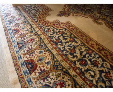 A Persian style modern machine woven rug, the central panel set with floral decorated medallion on a fawn ground within a ste