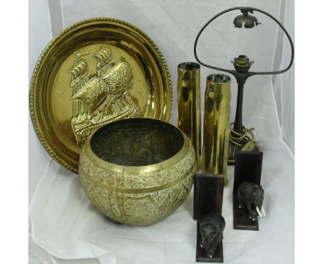 A collection of various brass ware to include a Benares type table on folding base, a Dutch style embossed charger, a pair of