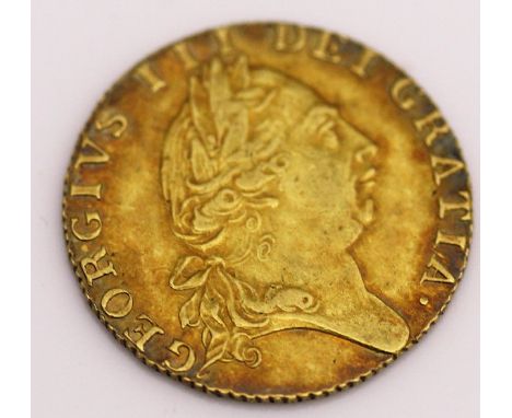 A George III spade guinea dated 1789 CONDITION REPORTS Light surface scratches, tarnishing to the outer edge on both sides, s