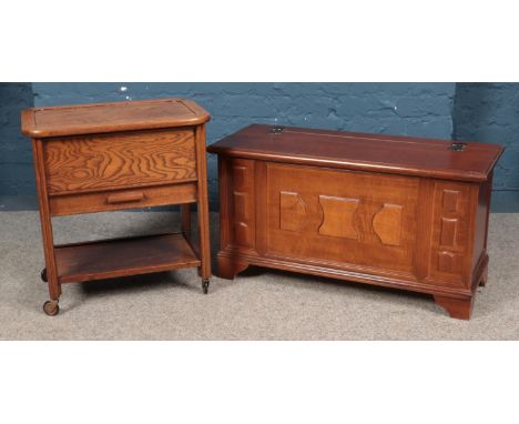 A small yew wood blanket box, together with a vintage 'Arnold' sewing trolley.  