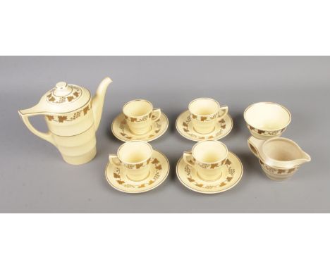 A Wedgwood Matt Straw tea service to include tea pot, milk jug, cups and saucers.  