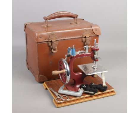 A vintage cased child's sewing machine.  