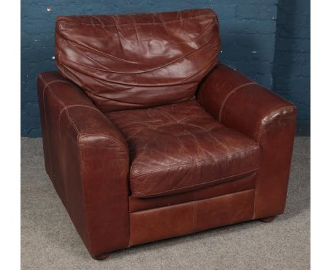 A brown leather arm chair by The Vintage Tanning Company by Halo.  Some tears to webbing on back rest and seat.