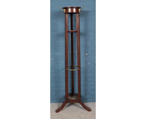 A large mahogany cylindrical coat and stick stand, with drip tray. 173cm tall.  One leg missing. Scuffs to other legs. Some a