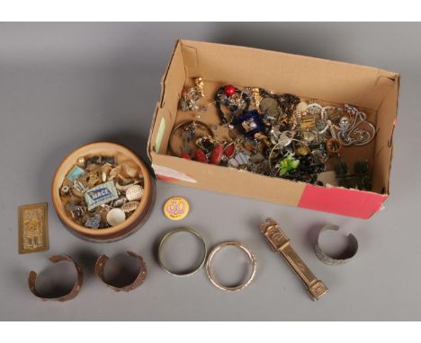 A box containing an assortment of items, including bass door knocker formed as a longcase clock, costume jewellery and bangle