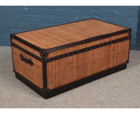 A large wood and rattan trunk.  