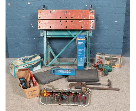 A large collection of tools, to include Workmate bench, electric sanders, tap and die set, spanners, pliers, tripod laser lev