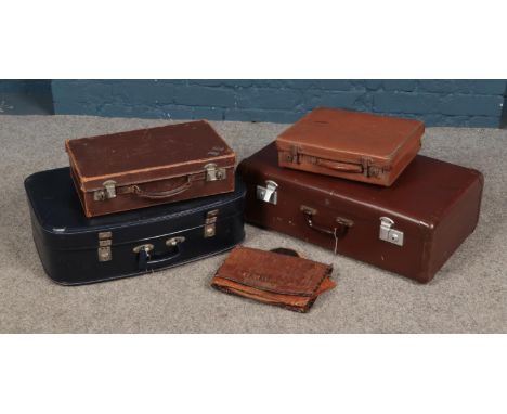 Four vintage suitcases and an Egyptian bag.  