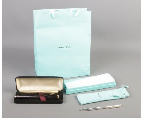 A Tiffany silver ballpoint pen, in drawstring bag and box, together with a cased L'Plume fountain pen, with Iridium nib.  Pen