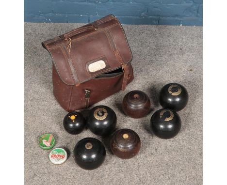 A bag of vintage lawn bowls to include several Hemselite examples. Seven total.  