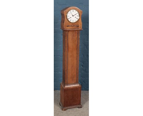 An oak cased miniature longcase clock, chiming on a coiled gong, with UWS movement. Height: 132cm  Pendulum missing, glass mi