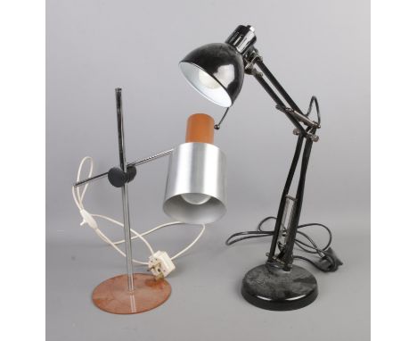 A black angle poise desk lamp along with one other adjustable light.  