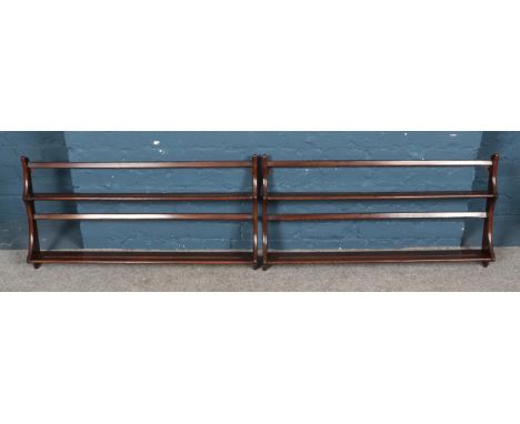 A pair of Ercol dark elm hanging wall racks. 97cm wide.  