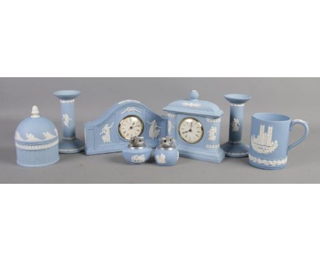 A collection of Wedgwood jasperware. Includes two clocks, pair of candlesticks, lighters etc.  Crack to base of one candlesti