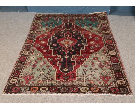 A vintage Persian Herlz village rug. Approx. dimensions 194cm x 152cm.  