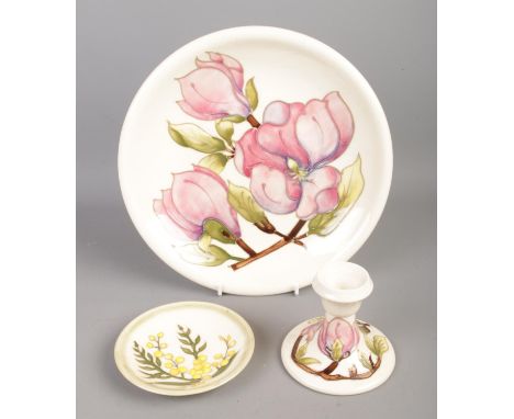 Three pieces of Moorcroft pottery, to include large magnolia dish and candlestick and wattle pin dish/coaster. Diameter of la