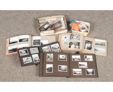 Two boxes of vintage monochrome photographs and negatives.  